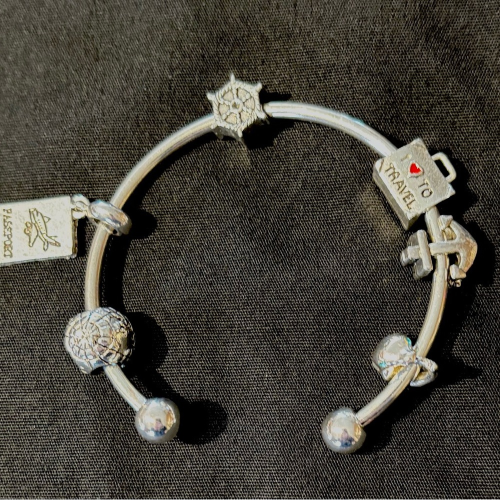 silver colored travel charms themed bracelet